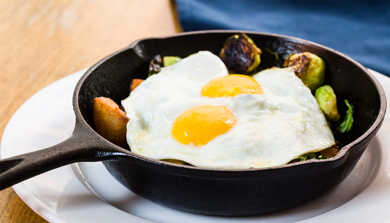 Veggie hash - sunny eggs, brussels sprouts, spinach, onion & potatoes.